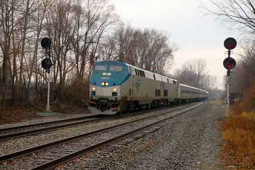 Amtraks's Wolverine train passes through Ypsilanti on a dreary April day. The train connects Chicago and Detroit and it saw an increase in ridership of 9 percent in the first six months of the current fiscal year. Photo by Steve Sobel.